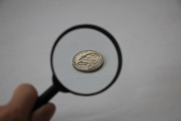 magnifying glass and dollar