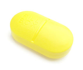 Container with pills on white background