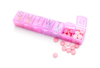 Container with pills on white background