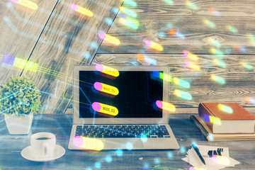 Double exposure of desktop computer and technology theme hologram. Concept of software development.