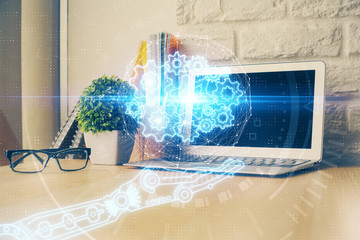 Double exposure of desktop computer and technology theme hologram. Concept of software development.