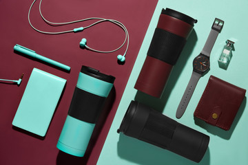 Men's accessories, devices and portable thermos mug.  Lifestyle and environmental consiousness concept. Flat lay, top view