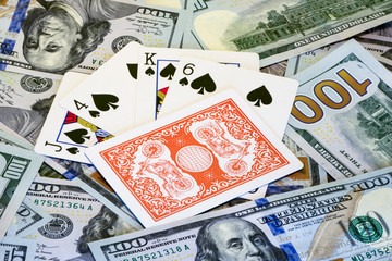 Poker combinations of cards on the background of dollar bills