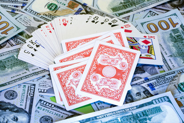 Deck of cards on the background of dollar bills