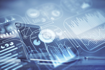 Computer on desktop in office with technology theme hologram. Multi exposure. Tech concept.