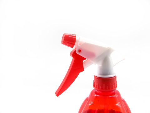red spray bottle with liquid on a white background