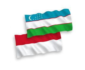 Flags of Indonesia and Uzbekistan on a white background