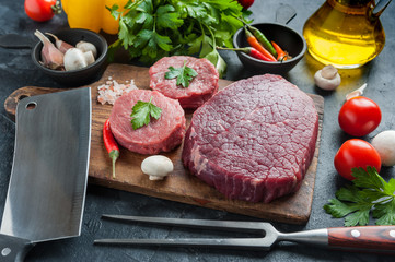 Beef steaks ready to cooking with vegetables