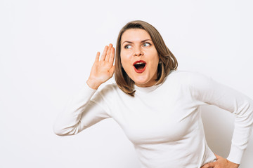 Overhears a woman, tries to listen.