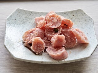 Serve slices raw fermented pork on dish