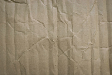 Crumpled of cardboard sheet used as a background. Brown corrugated texture paper.