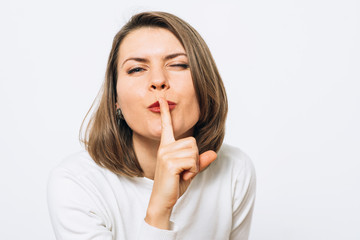 Naklejka premium woman put finger on her lips