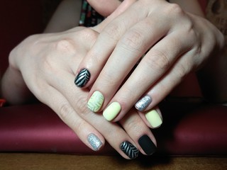 The manicurist excellently made her work a beautiful manicure with a polish gel on her hands and the client is happy