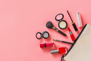 Obraz na płótnie Canvas Make up items on pink color background. Set of luxury decorative cosmetics flat lay, top view, mockup, template. Minimal style. Beauty blogger concept.