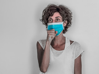 woman wearing a medical face mask, coughing and protecting from corona virus covid-19