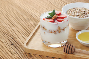 a cup of yogurt and strawberries on the table
