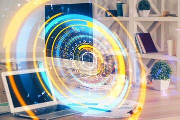 Computer on desktop in office with technology theme hologram. Multi exposure. Tech concept.