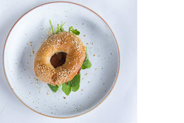  Bagel sandwich with cream cheese, salmon and arugula isoalated on white background