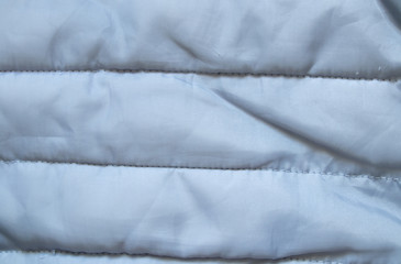 black puffer jacket material as background closeup