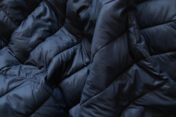 black puffer jacket material as background closeup