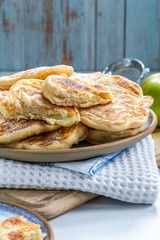 Fluffy homemade pancakes with apple dusted with icing sugar