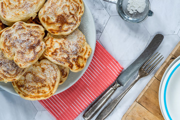 Fluffy homemade pancakes with apple dusted with icing sugar - overhead view