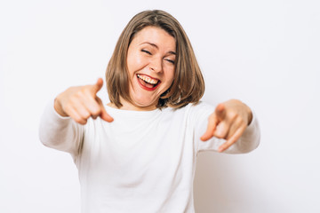 studio portrait of a beautiful girl pointing to the camera