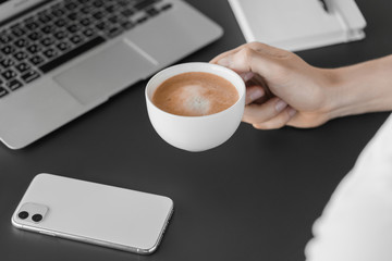 Businessman holding a cup in hand. Coffee break office. 