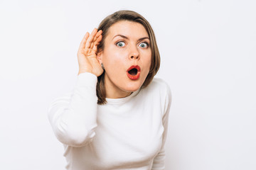 Overhears a woman, tries to listen.
