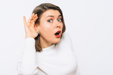 Overhears a woman, tries to listen.