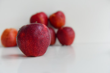 ripe red apples in water drops close up