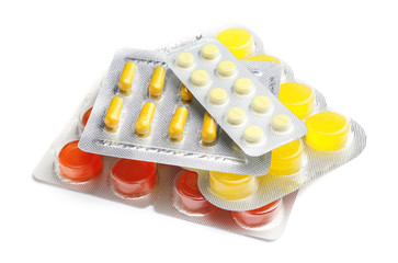 Different pills on white background