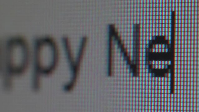 Typing congratulations on New Year. Close up view of screen.