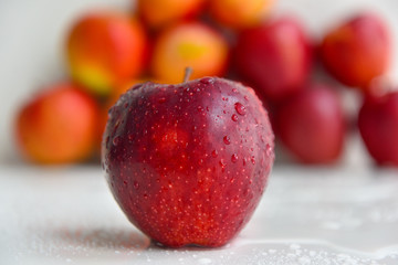 ripe red apples in water drops close up