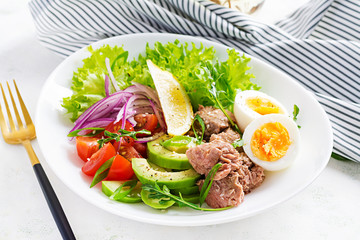Healthy food. Tuna fish salad with eggs, lettuce, cherry tomatoes, avocado and red onions.  French cuisine.