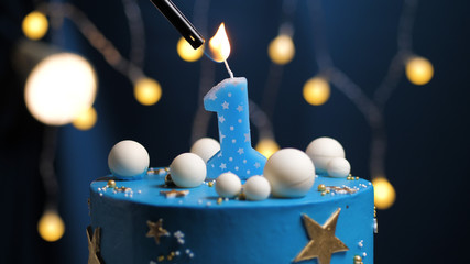 Birthday cake number 1 stars sky and moon concept, blue candle is fire by lighter. Copy space on...