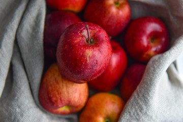 ripe red apples in water drops close up