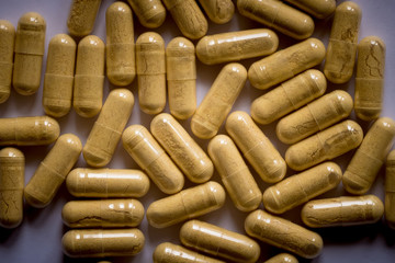 yellow pills scattered on the table