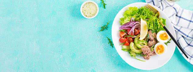 Healthy food. Tuna fish salad with eggs, lettuce, cherry tomatoes, avocado and red onions.  French cuisine. Top view, copy space, banner