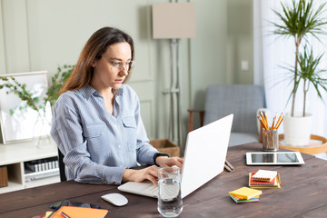 Businesswoman working with laptop at home