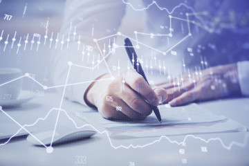 Financial trading chart multi exposure with man desktop background.
