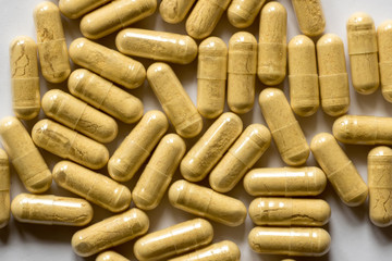 yellow pills scattered on the table