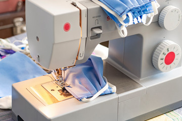 Sewing blue medical masks to protect against Covid-19	
