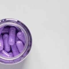 purple pills in a jar