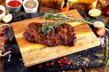 rib eye steak with margarine on a cutting Board