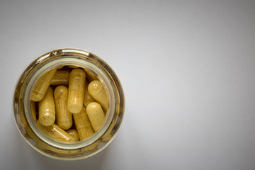 yellow pills in a jar