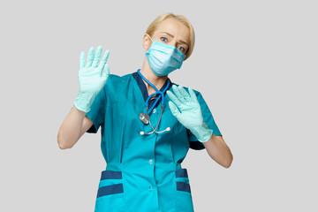 medical doctor nurse woman wearing protective mask and rubber or latex gloves - scared and stressed