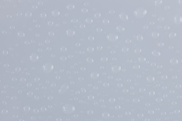 Water drops on glossy glass surface texture abstract background