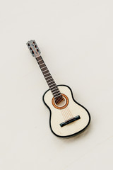 mini guitar on a wooden background