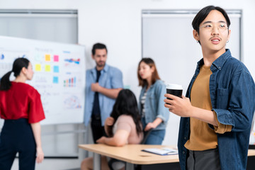 Smart asian startup small entrepreneur  standing confident portrait with  friends partner casual meeting brainstorm with white board and business financce paper chart anslysis in office background